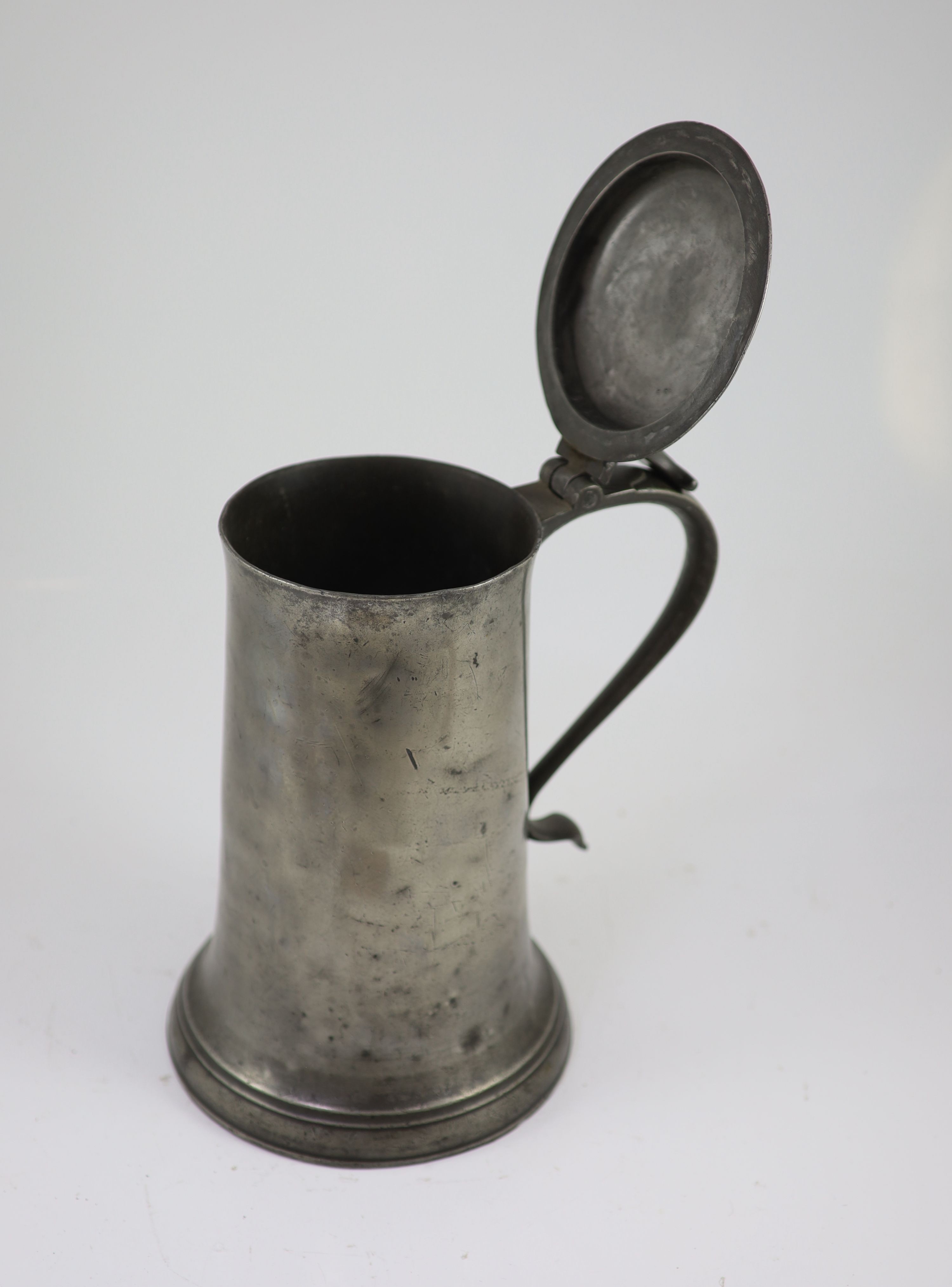 An early 17th century pewter flagon of large proportions H 34cm.